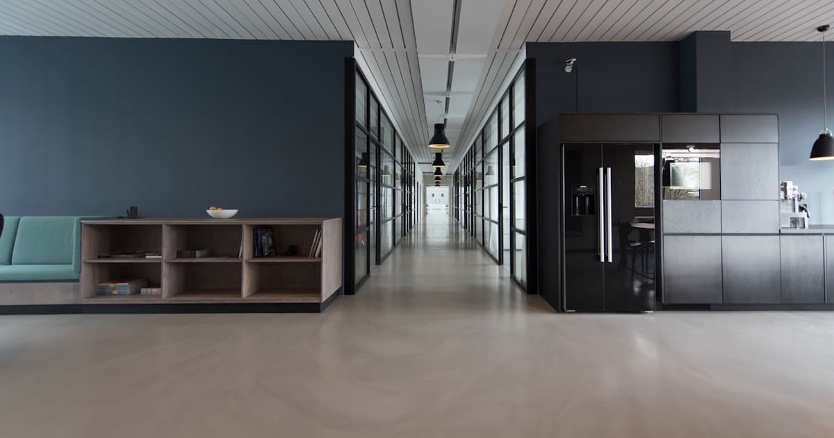 Modern enterprise office corridor with glass-walled meeting rooms - representing the enterprise governance vs flexibility decision between ClickUp and Wrike