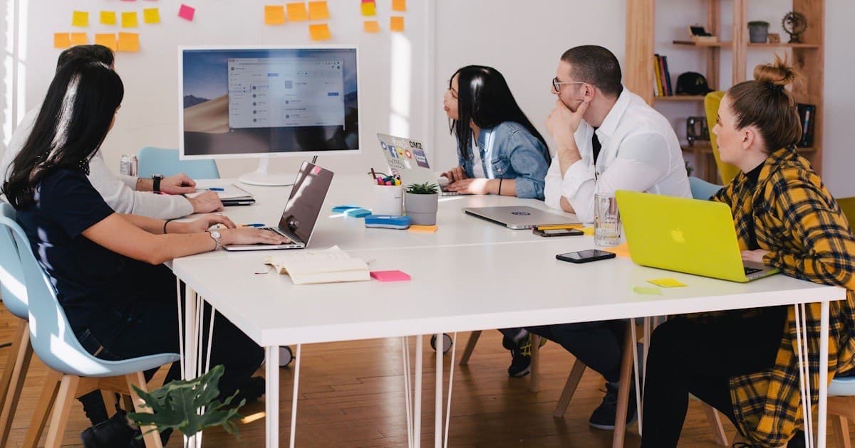 Team comparing CRM platforms side by side in a modern collaborative workspace