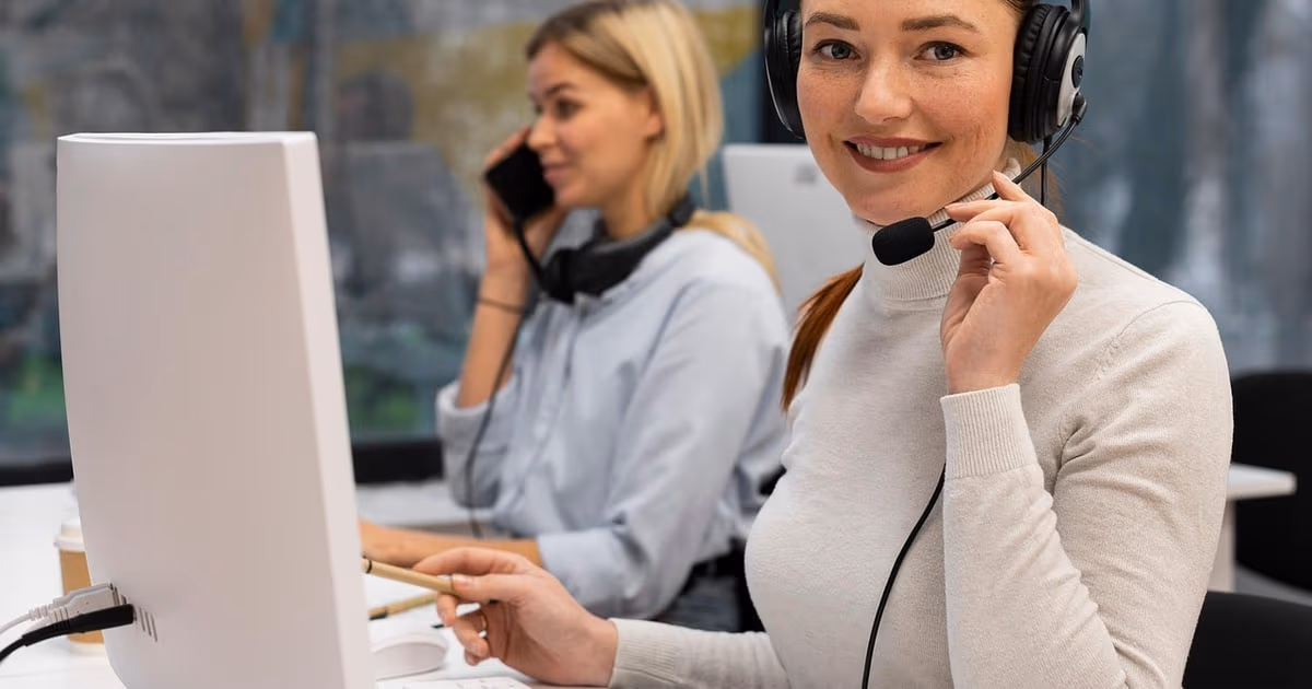 Support team laptop showing a customer conversation list next to a phone with WhatsApp messages, representing Freshdesk alternatives in 2026