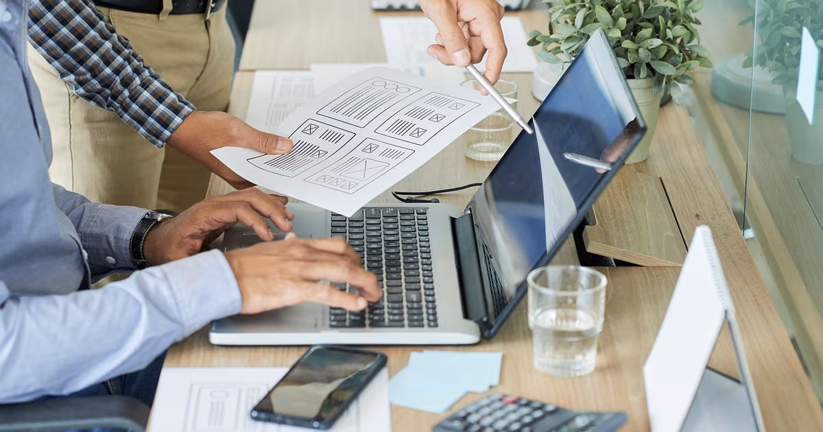 Small business owner comparing simpler GoHighLevel alternatives on a laptop in 2026