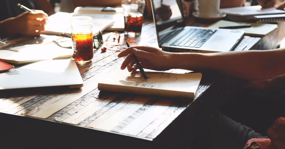 Laptop and notebook on a clean desk representing the best Google Workspace alternatives for business teams in 2026