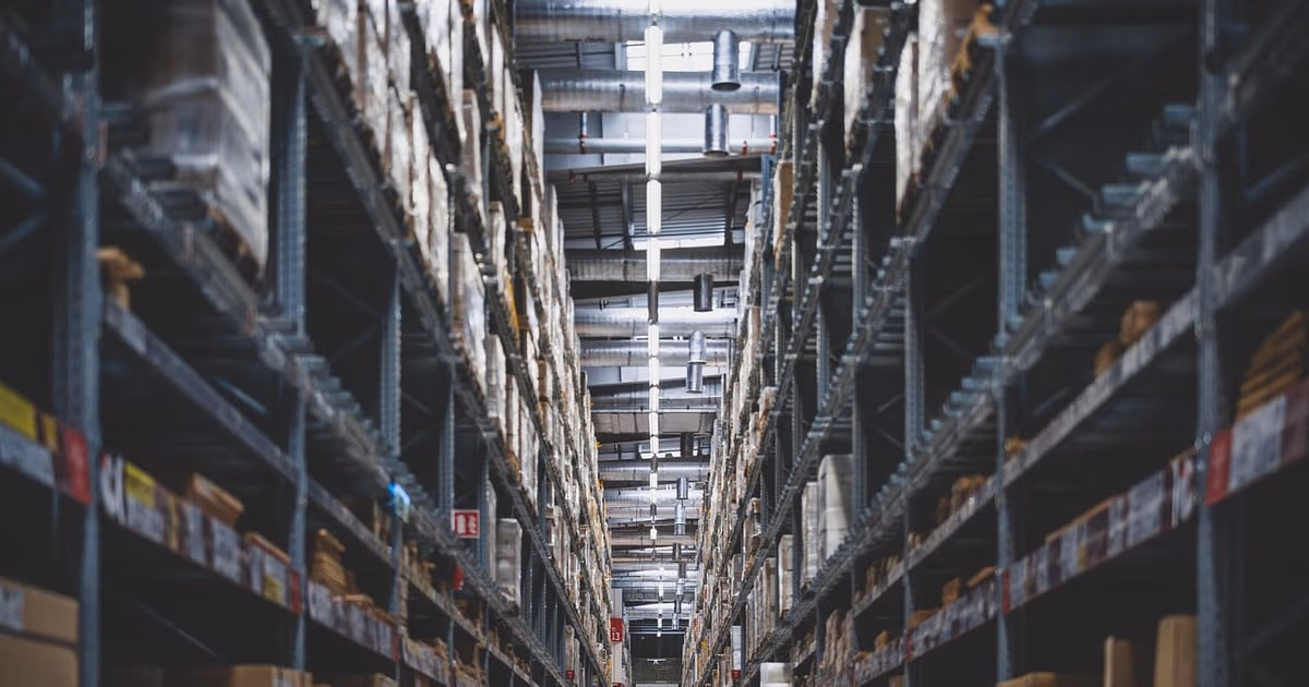 Small business owner managing stock and customer orders with inventory management software in 2026