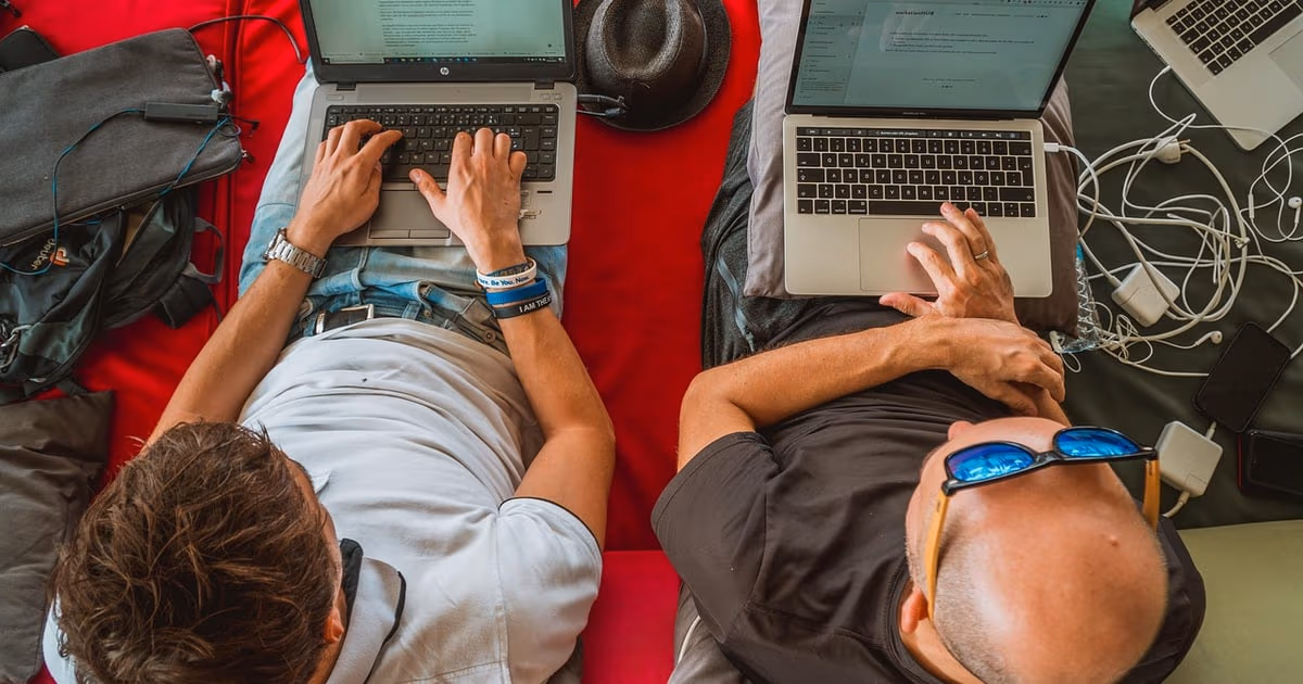 Freelance designer running client work and follow-ups from a simple CRM on a laptop