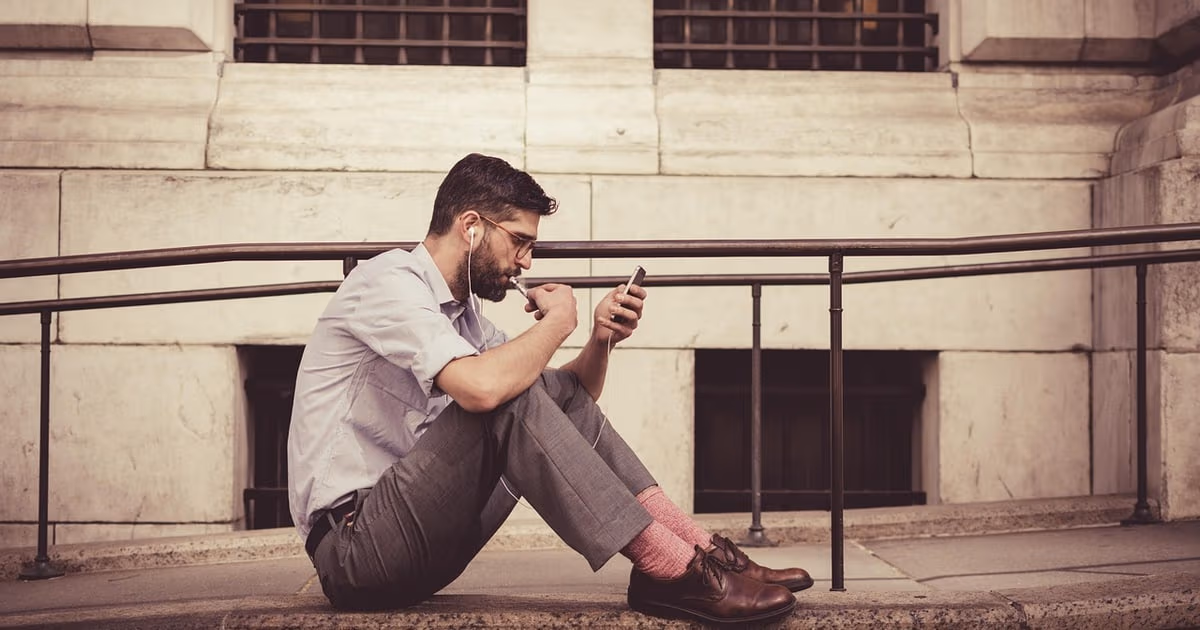 Small business owner updating customer records on a phone between appointments, representing mobile CRM for small business