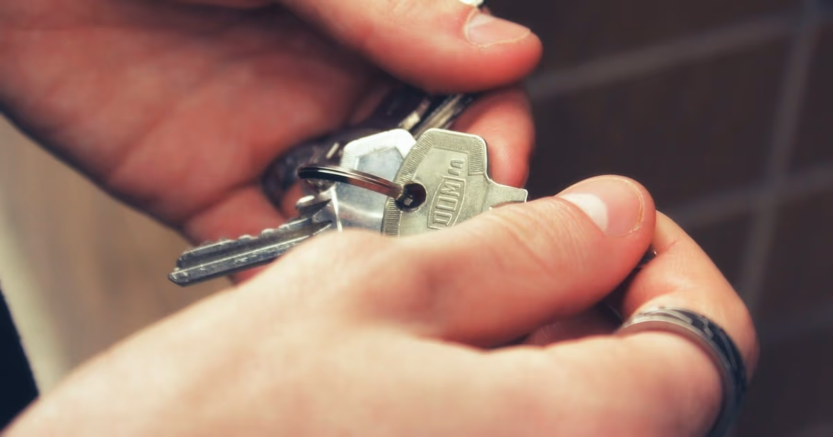 Property manager shaking hands with a homeowner outside a short-term rental apartment building