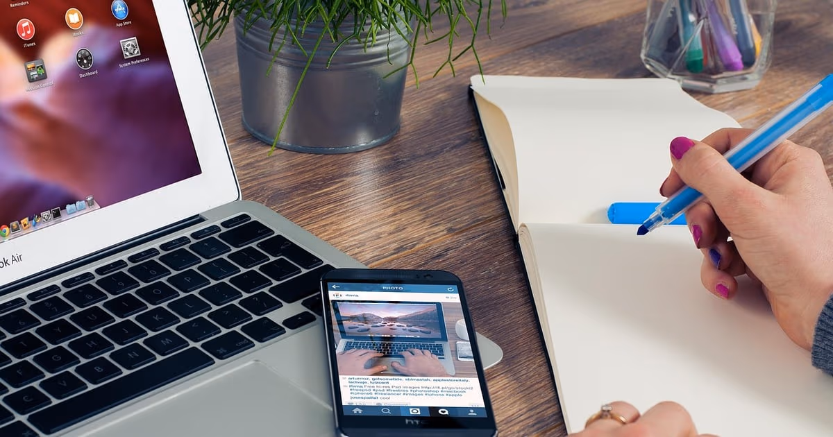 Two smartphones on a desk, one for personal chats and one for a separate WhatsApp Business number