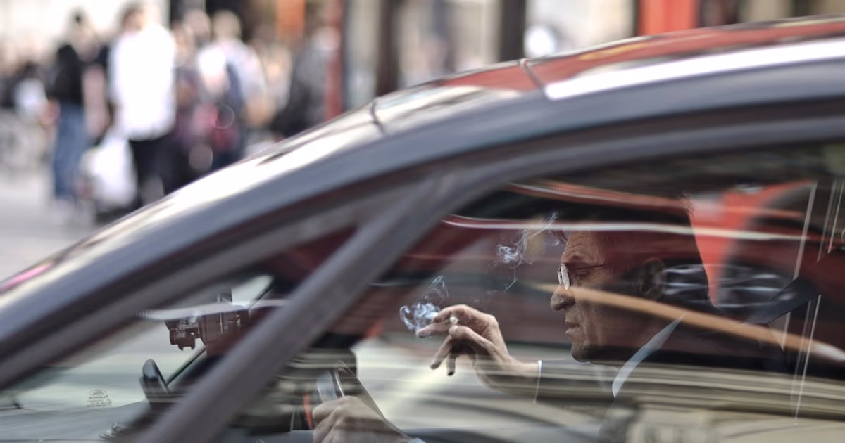 Business owner recording a voice note in a car to update customer records, representing voice notes going into a CRM