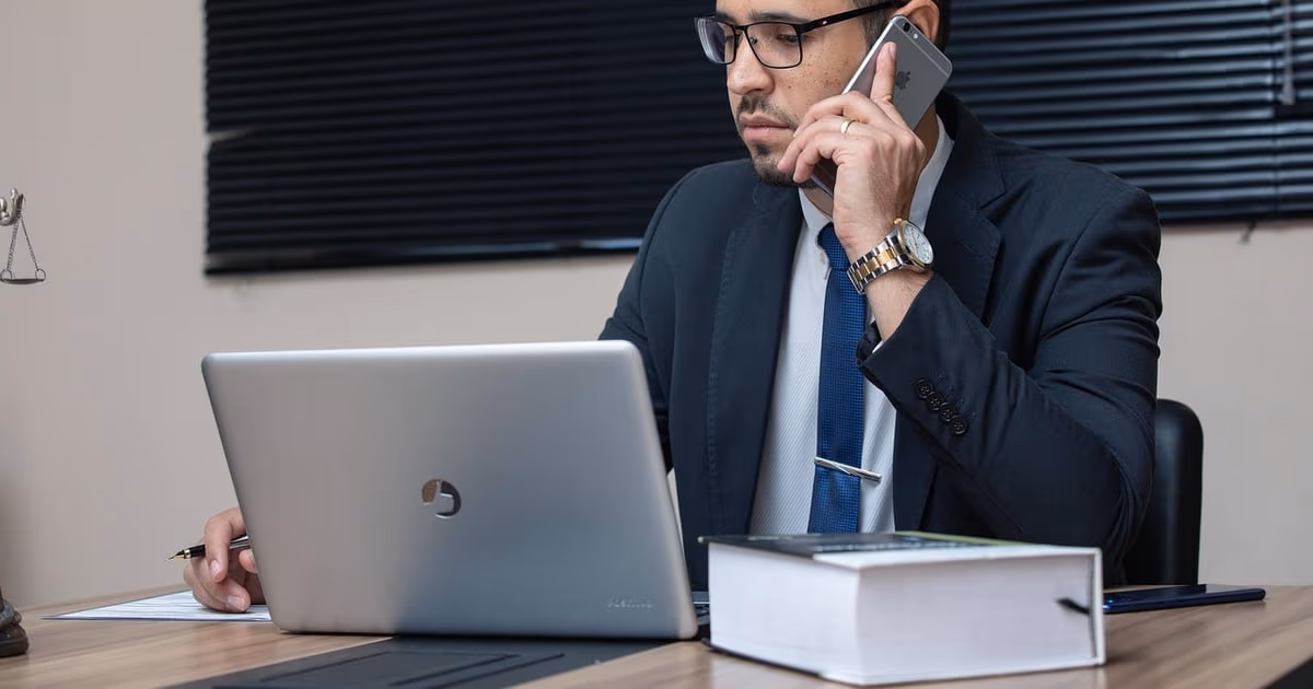 Lawyer reviewing case intake on a phone, representing a WhatsApp chatbot for law firms in 2026