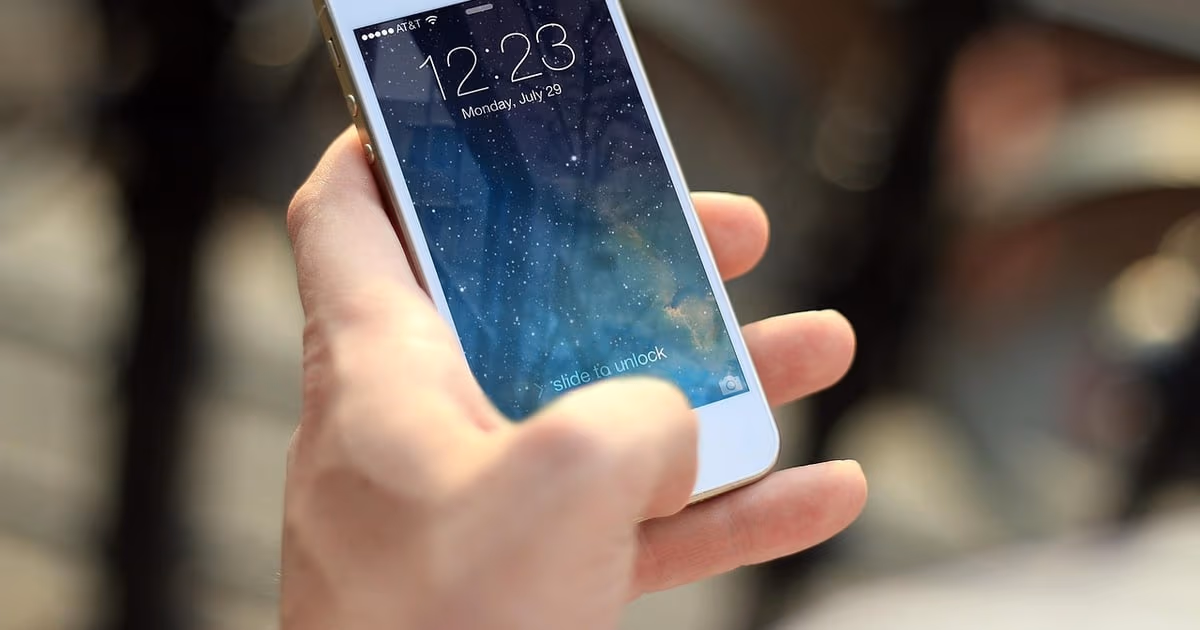 Hand holding a smartphone ready for new messages, representing WhatsApp greeting messages for new customers